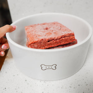 RawFedK9 PMR patties served in a white bowl, highlighting a complete and balanced raw meal made from muscle meat, bone, and organ for dogs.