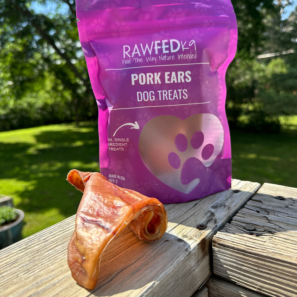 RawFedK9 dehydrated pig ears displayed next to their branded treat bag, showcasing natural, long-lasting single-ingredient chews for dogs.